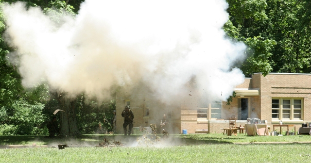 Muskatatuck Urban Training Cntr., Indiana, United States-Marines from Battalion Landing Team 2/6, 26th Marine Expeditionary Unit, move between buildings during training, June 10, 2008, at Muscatatuck Urban Training Center in Butlerville, Ind. The Marines were using the facility during the 26th MEU's Realistic Urban Training exercise, part of the MEU's predeployment training period. (Official USMC photo) (Released), 6/10/2008 10:33 AM.